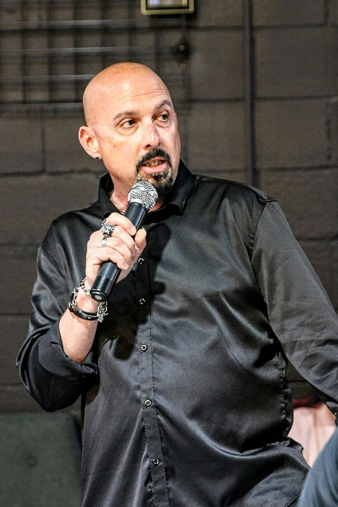 Man speaking into a microphone during a panel talk